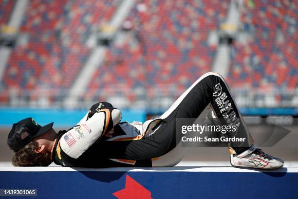 Noah Gragson, driver of the Bass Pro Shops/TrueTimber/BRCC Chevrolet, lays on the wall during qualifying for the NASCAR Xfinity Series Championship...