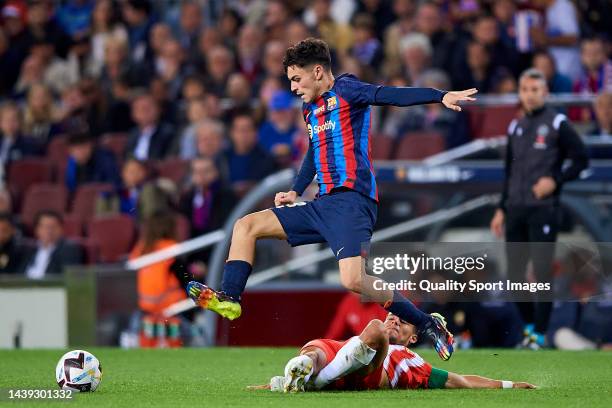 Pedro Gonzalez Lopez "Pedri" of FC Barcelona competes for the ball with Lucas Robertone of UD Almeria during the LaLiga Santander match between FC...