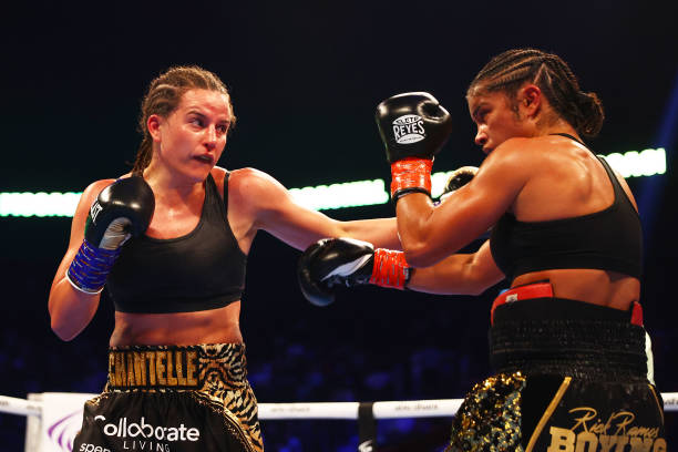 Chantelle Cameron punches Jessica McCaskill during the IBF, IBO, WBA, WBC, WBO, Undisputed Super-Lightweight Championship Title fight between...