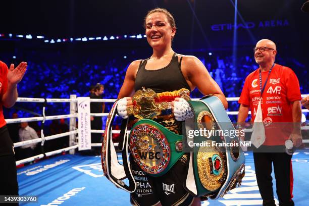 Chantelle Cameron celebrates with the IBF, IBO, WBA, WBC and WBO World Title belts after victory in the IBF, IBO, WBA, WBC, WBO, Undisputed...