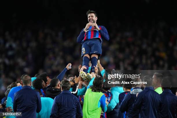 Gerard Pique of FC Barcelona is thrown into the air by their team mates after the LaLiga Santander match between FC Barcelona and UD Almeria at...