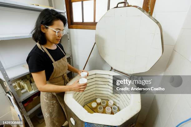 ceramist drying clay pieces in an oven - kiln stock pictures, royalty-free photos & images