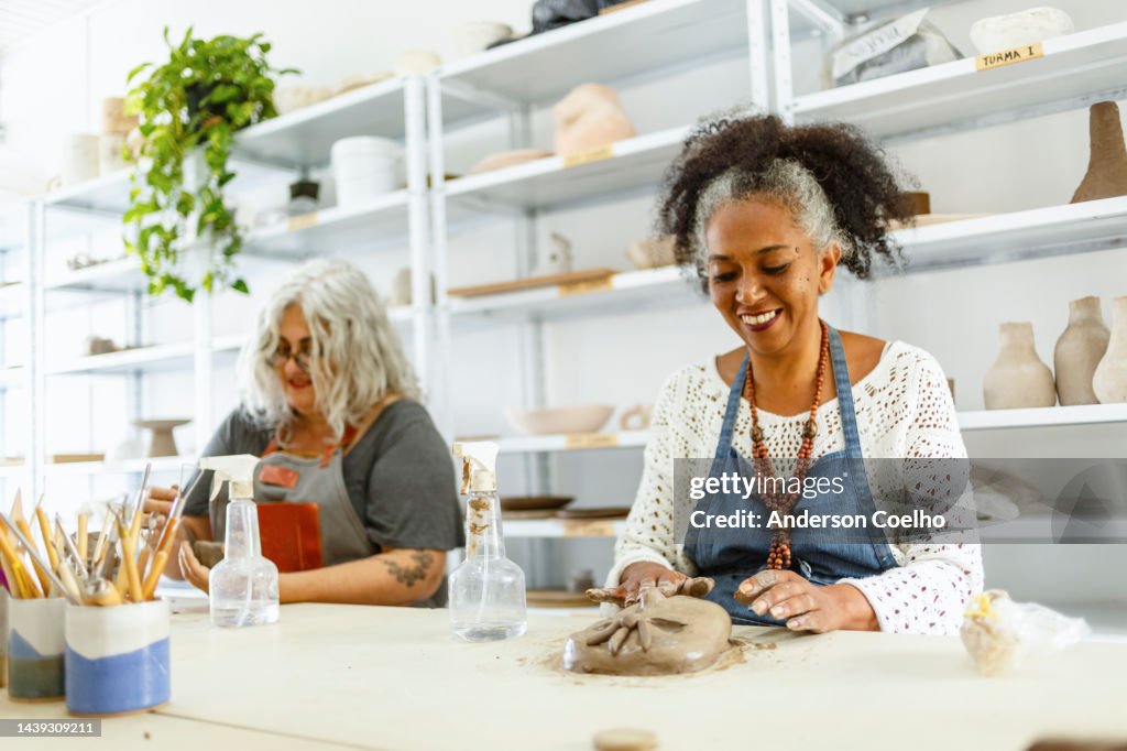 Middle-aged people in a pottery class