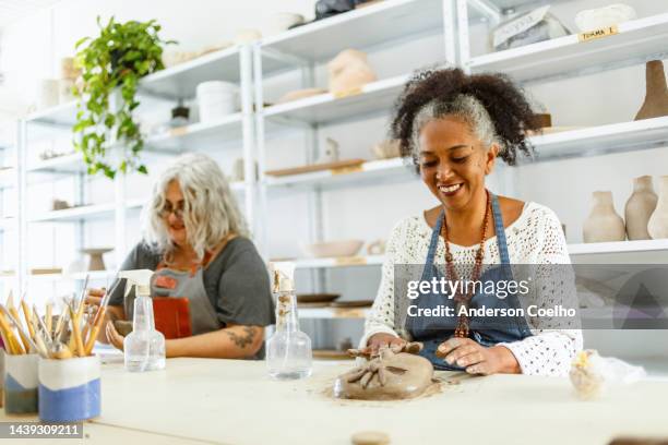 middle-aged people in a pottery class - art and craft stock pictures, royalty-free photos & images