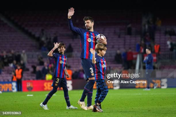 Gerard Pique of FC Barcelona and their children Milan Pique Mebarak and Sasha Pique Mebarak wave to fans after the LaLiga Santander match between FC...