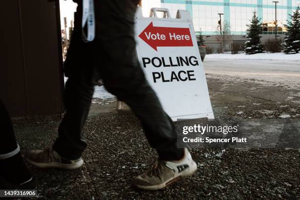 People walk into a polling station to cast early ballots for the upcoming midterm elections on November 05, 2022 in Anchorage, Alaska. Early and...