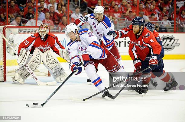 Anton Stralman of the New York Rangers handles the puck against Dennis Wideman of the Washington Capitals in Game Four of the Eastern Conference...