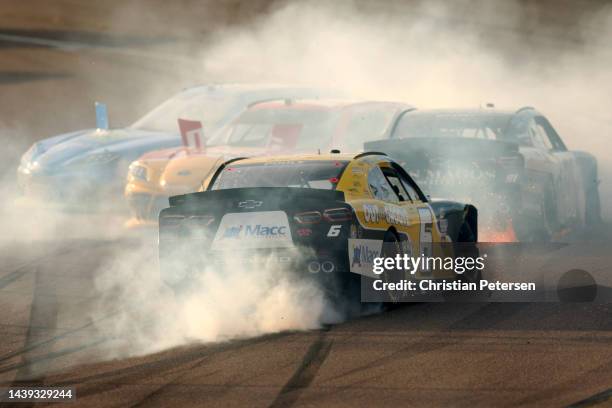 Brennan Poole, driver of the Out of The Groove Chevrolet, spins into Mason Massey, driver of the LOS MAGOS Chevrolet, after an on-track incident...