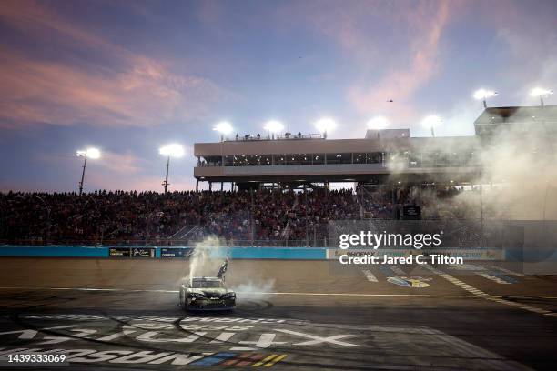 Ty Gibbs, driver of the Monster Energy Toyota, celebrates with a burnout after winning the NASCAR Xfinity Series Championship at Phoenix Raceway on...