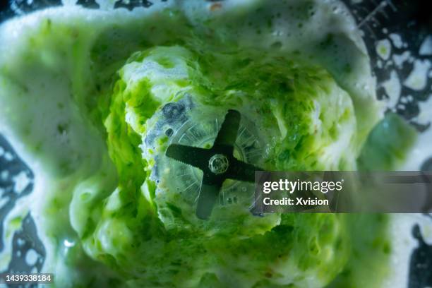 green pepper chili under high speed blending synced in high speed photography - smoothies stock pictures, royalty-free photos & images