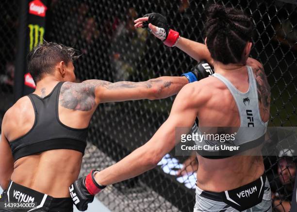 Amanda Lemos of Brazil punches Marina Rodriguez of Brazil in a strawweight fight during the UFC Fight Night event at UFC APEX on November 05, 2022 in...