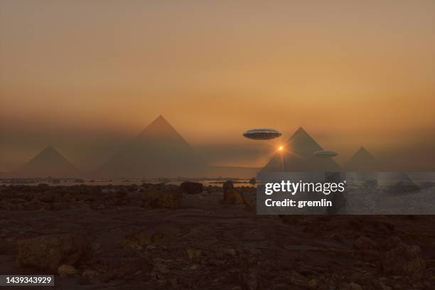 flying ufos over mysterious pyramids on distant planet - pyramid shape stock pictures, royalty-free photos & images