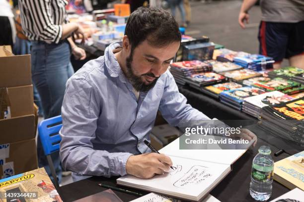The writer Isaac Sanchez signs books at the Madrid Cómic Pop Up 2022 at Ifema on November 05, 2022 in Madrid, Spain.
