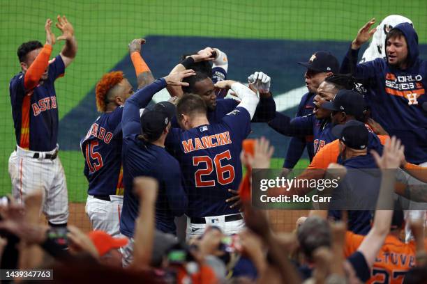 Yordan Alvarez of the Houston Astros celebrates with teammates after hitting a three-run home run against the Philadelphia Phillies during the sixth...