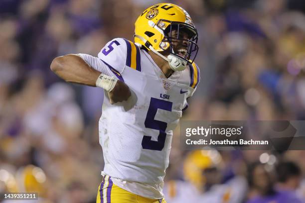 Jayden Daniels of the LSU Tigers celebrates throwing for a touchdown during the fourth quarter against the Alabama Crimson Tide at Tiger Stadium on...