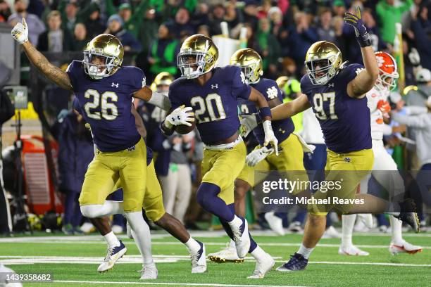 Benjamin Morrison of the Notre Dame Fighting Irish celebrates an interception with teammates against the Clemson Tigers during the second half at...