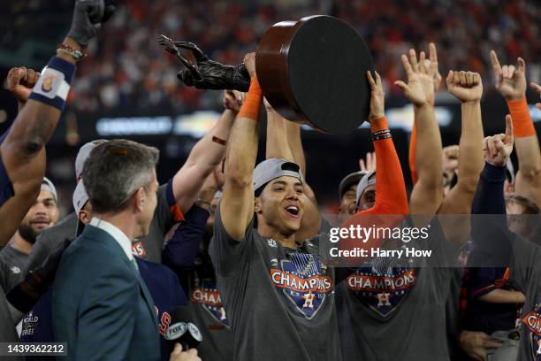 Jeremy Pena of the Houston Astros lifts the commissioner's trophy after defeating the Philadelphia Phillies 4-1 to win the 2022 World Series in Game...