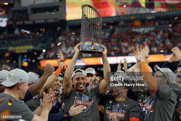 Michael Brantley of the Houston Astros celebrates with the Commissioner's Trophy after defeating the Philadelphia Phillies 4-1 in Game Six of the...