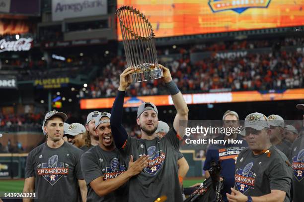 Kyle Tucker of the Houston Astros holds up the Commissioner's Trophy after defeating the Philadelphia Phillies 4-1 in Game Six to win the 2022 World...