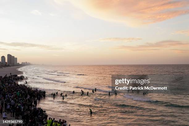 Age group athletes enter the water at the start of the swim course at IRONMAN Florida on November 05, 2022 in Panama City Beach, Florida.