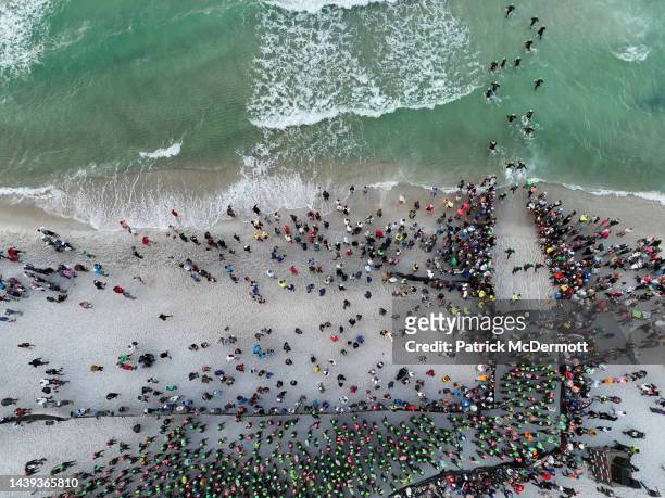 An aerial view of age group athletes entering the water at the start of the swim course at IRONMAN Florida on November 05, 2022 in Panama City Beach,...