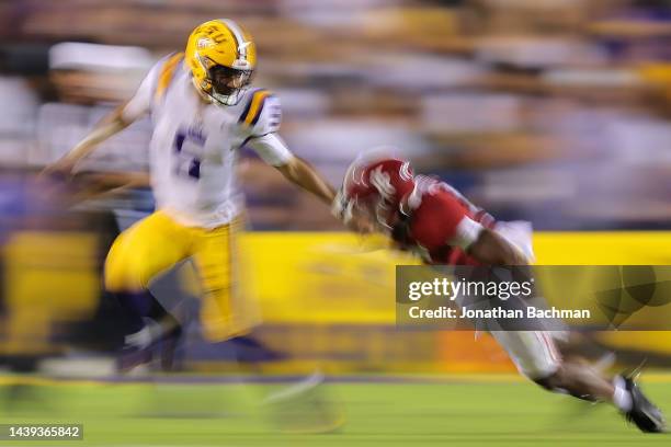 Jayden Daniels of the LSU Tigers is sacked by Dallas Turner of the Alabama Crimson Tide during the second half at Tiger Stadium on November 05, 2022...