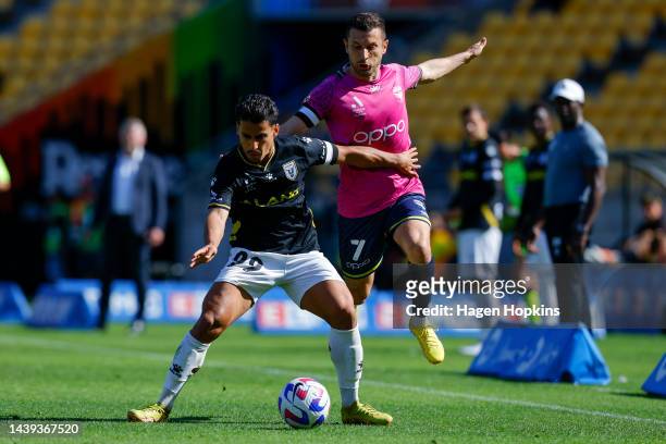 Daniel Arzani of Macarthur FC is challenged by Kosta Barbarouses of the Phoenix during the round five A-League Men's match between Wellington Phoenix...