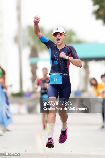 Katrine Brock celebrates as she crosses the finish line as the first female age group athlete at IRONMAN Florida on November 05, 2022 in Panama City...