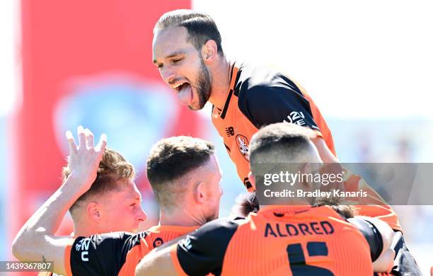 Charles Austin of the Roar is congratulated by team mates after scoring a goal during the round five A-League Men's match between Brisbane Roar and...