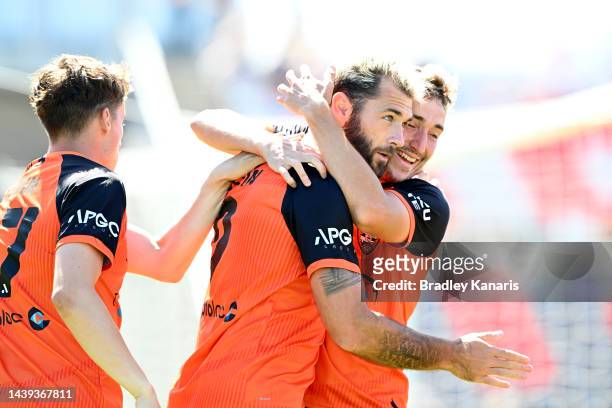 Charles Austin of the Roar is congratulated by team mates after scoring a goal during the round five A-League Men's match between Brisbane Roar and...