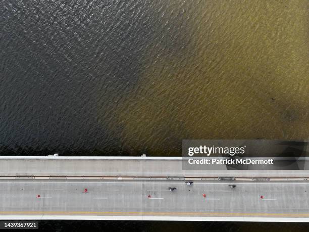 An aerial view of age group athletes competing in the bike course at IRONMAN Florida on November 05, 2022 in Panama City Beach, Florida.