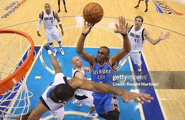 Russell Westbrook of the Oklahoma City Thunder takes a shot against Brandan Wright of the Dallas Mavericks during Game Four of the Western Conference...