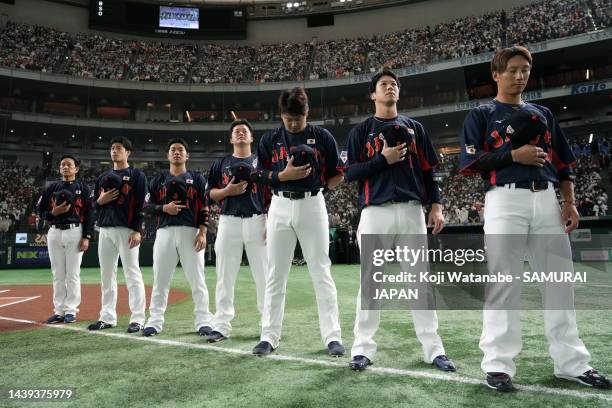 Samurai Japan players line up for the national anthem prior to the game between Samurai Japan and Yomiuri Giants at Tokyo Dome on November 6, 2022 in...