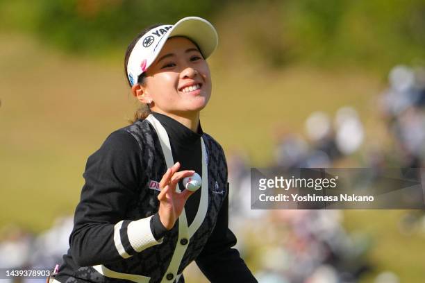 Kana Nagai of Japan acknowledges the gallery after holing out with the birdie on the 18th green during the final round of the TOTO Japan Classic at...