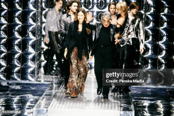 Designer Roberto Cavalli walks the runway at show finale.