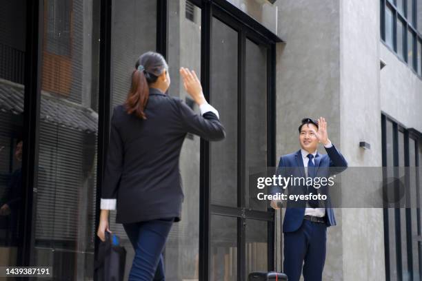 businessperson are working and travel outside office. - female waving on street stock pictures, royalty-free photos & images