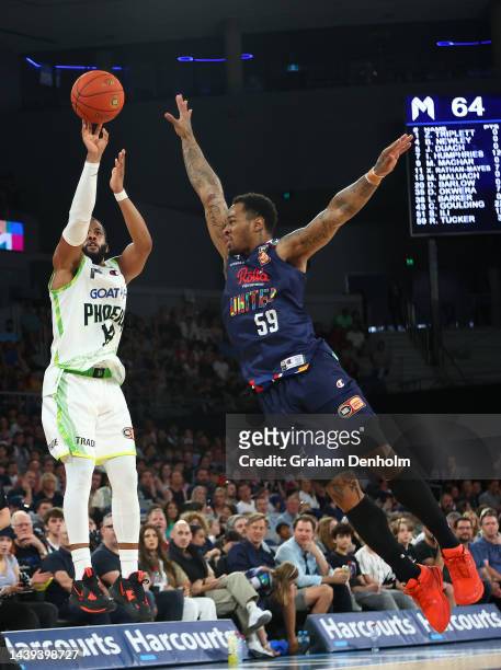 Gary Browne of the Phoenix shoots under pressure from Rayjon Tucker of United during the round six NBL match between Melbourne United and South East...