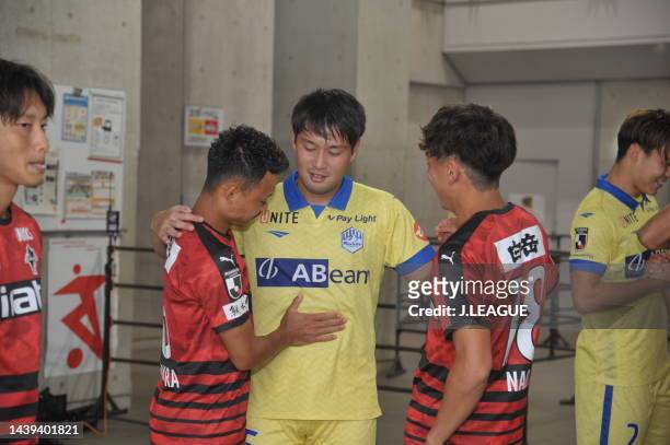 So KAWAHARA of Roasso Kumamoto and Naohiro SUGIYAMA of Roasso Kumamoto and Hiroki NODA of Montedio Yamagata hug prior to during the J.LEAGUE J.LEAGUE...