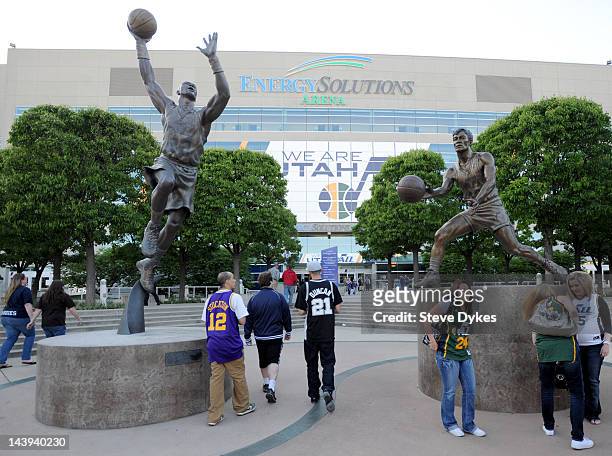 Fans stand in font of statues of Karl Malone and John Stockton before Game Three of the Western Conference Quarterfinals in the 2012 NBA Playoffs at...