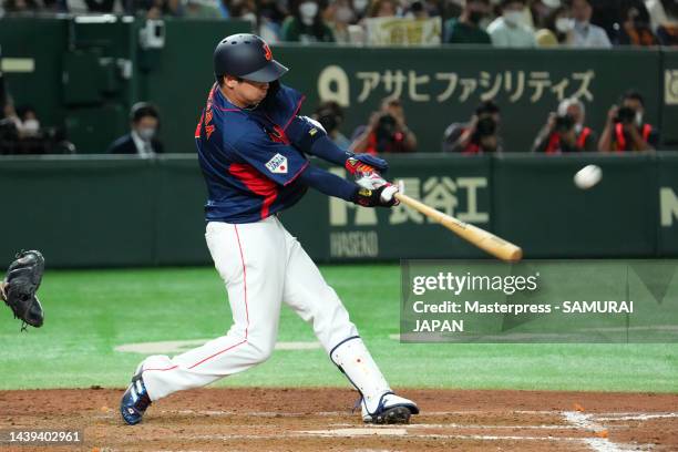 Infielder Tetsuto Yamada of Samurai Japan hits a solo home run to make it 5-4 in the eighth inning during the game between Samurai Japan and Yomiuri...