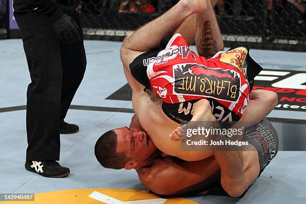 Nate Diaz Takes down Jim Miller during their Lightweight bout at Izod Center on May 5, 2012 in East Rutherford, New Jersey.