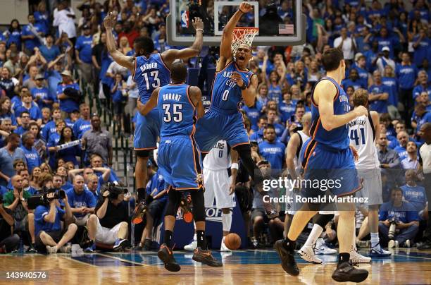 James Harden, Kevin Durant and Russell Westbrook of the Oklahoma City Thunder celebrate after scoring with 10 seconds against the Dallas Mavericks...
