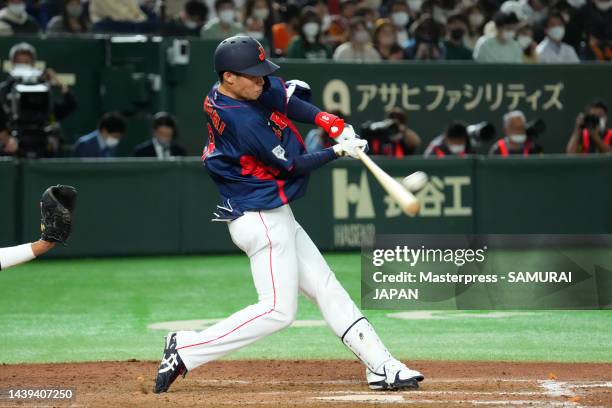 Outfielder Yasutaka Shiomi of Samurai Japan hits a solo home run to make it 7-4 in the ninth inning during the game between Samurai Japan and Yomiuri...