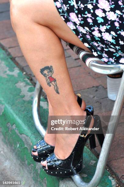 Native-American artist with a Betty Boop tatoo sits at her booth at the 2011 Santa Fe Indian Market in Santa Fe, New Mexico.