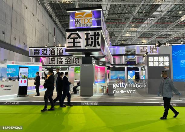 Visitors walk by the booth of the Hong Kong Trade and Development Council during the 5th China International Import Expo at the National Exhibition...