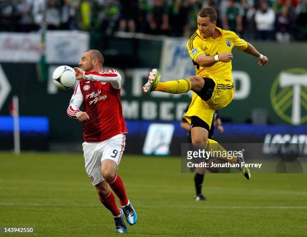 Josh Williams of the Columbus Crew clears the ball against Kris Boyd of the Portland Timbers of the Columbus Crew at Jeld-Wen Field on May 5, 2012 in...