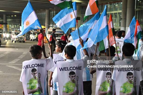 Young soccer fans wait to welcome Argentina's World Cup-winning goalkeeper Emiliano Martinez outside the Netaji Subhas Chandra Bose International...