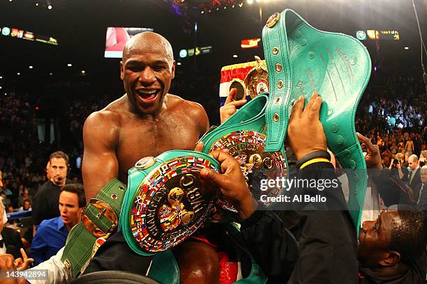 Floyd Mayweather Jr. Celebrates after defeating Miguel Cotto by unanimous decision during their WBA super welterweight title fight at the MGM Grand...