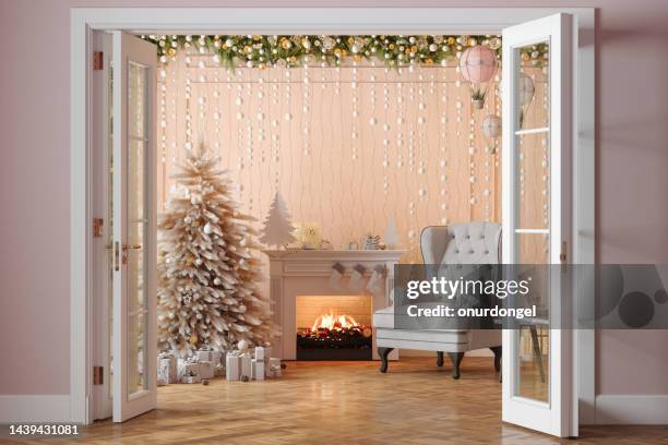 entrance of living room with christmas tree, ornaments, gift boxes, fireplace and armchair - christmas living room stock pictures, royalty-free photos & images