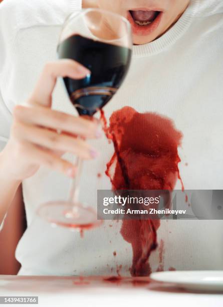 shocked woman spilled red wine onto the white shirt - white shirt stain stock pictures, royalty-free photos & images